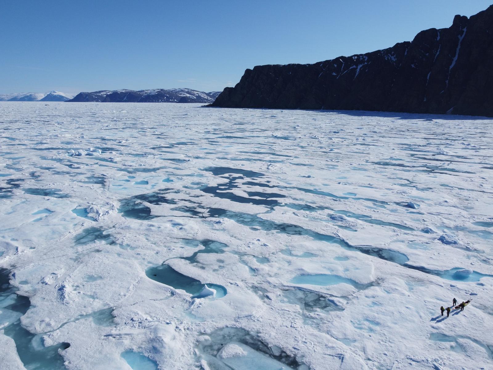 The team dragging their kayaks across vast Arctic sea ice