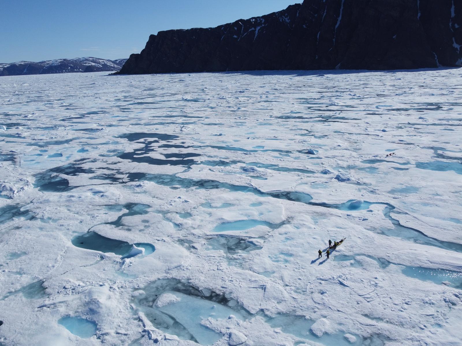 Drone view of kayaks among Arctic sea ice