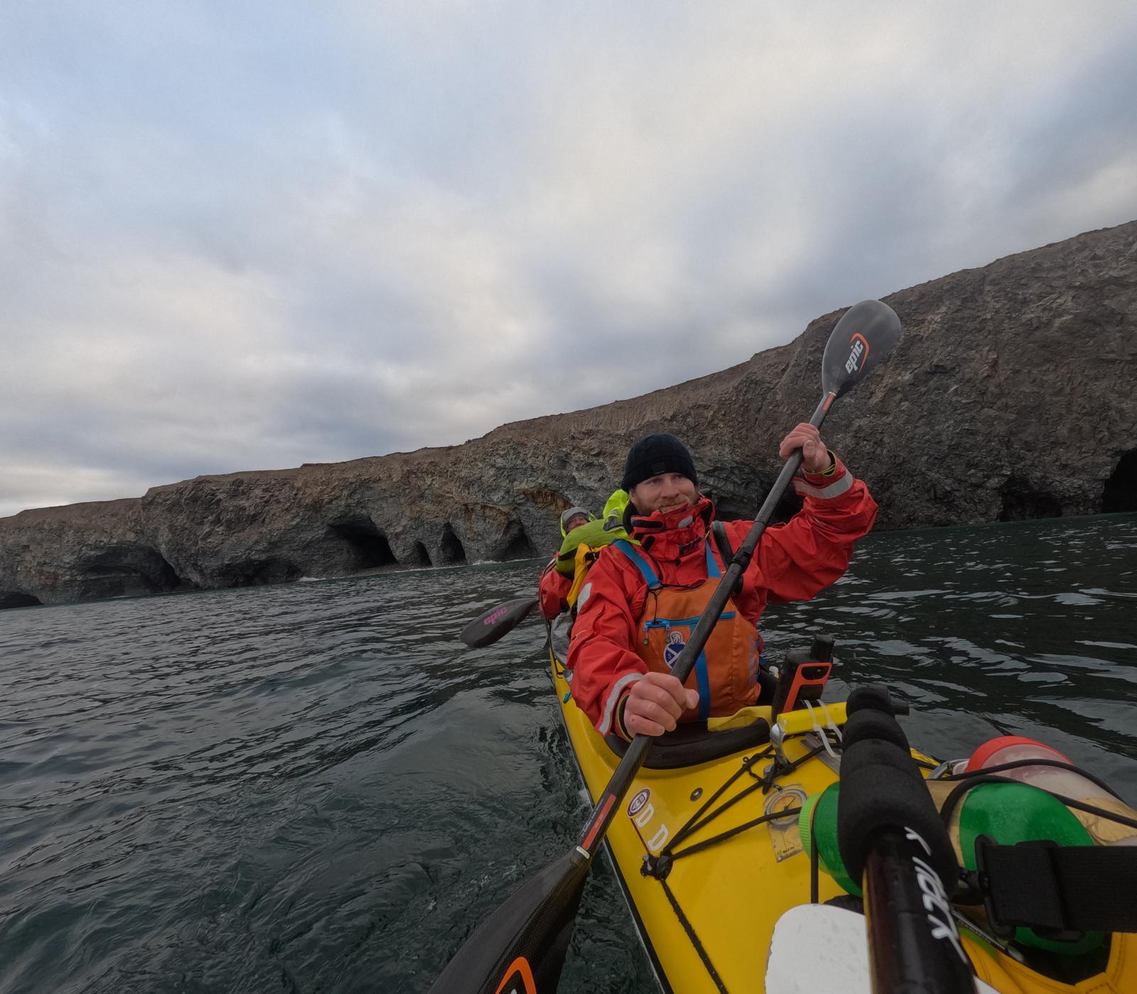 Mark Agnew paddling below Arctic cliffs